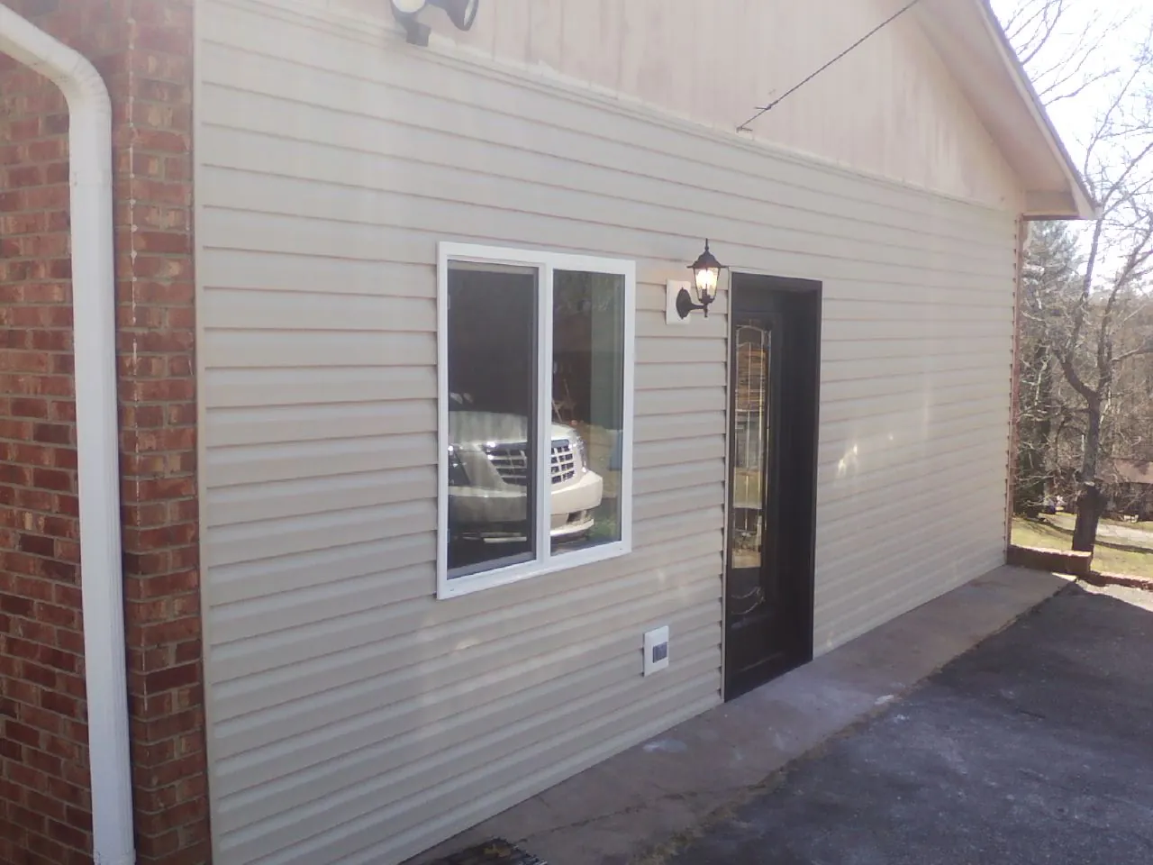 New vinyl siding and entry door on a room addition in Keysville