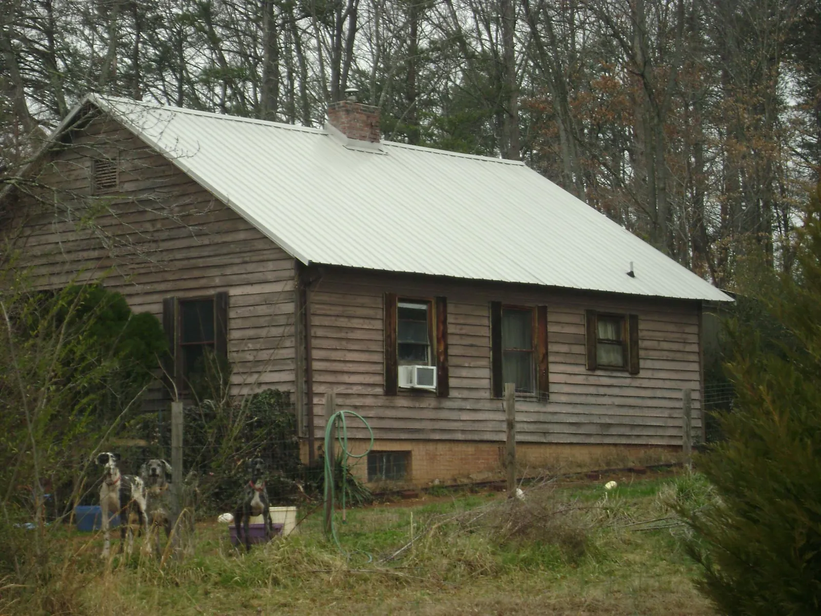 White metal roof on an old wood sided farmhouse, from a Metal Roof Installation job in Keysville